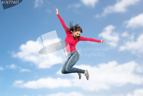 Image of smiling young woman jumping in air