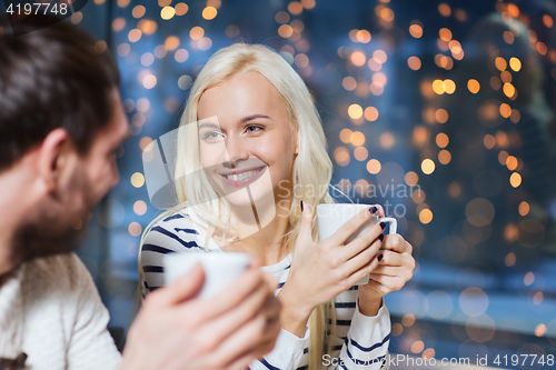 Image of happy couple drinking tea or coffee at cafe