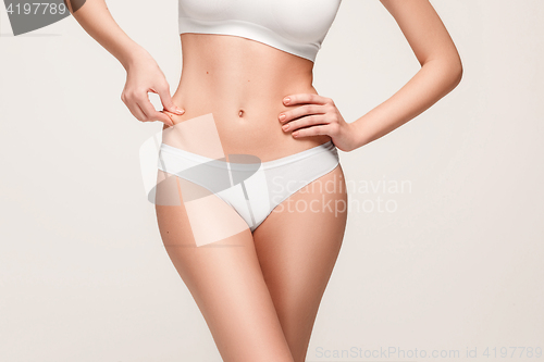 Image of Young, slim, healthy and beautiful woman in white lingerie