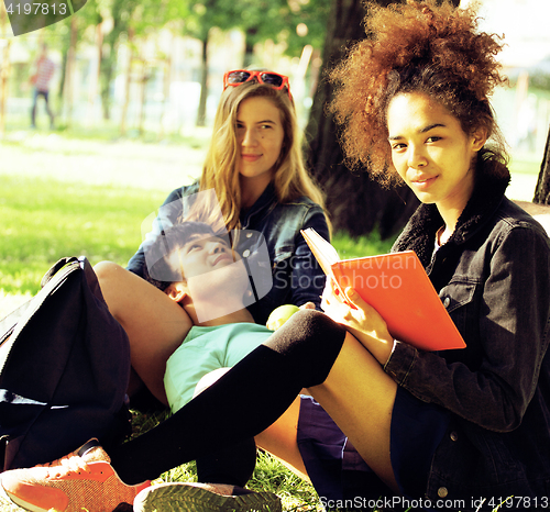 Image of cute group of teenages at the building of university with books 