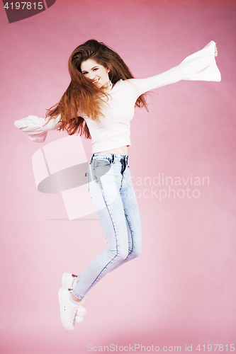Image of young pretty red hair ginger girl jumping isolated on pink background, lifestyle flying teen people happy smiling concept