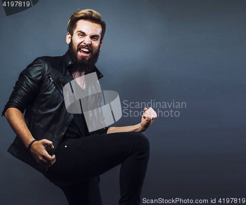 Image of portrait of young bearded hipster guy smiling on gray background close up, brutal man, lifestyle real people concept copyspace