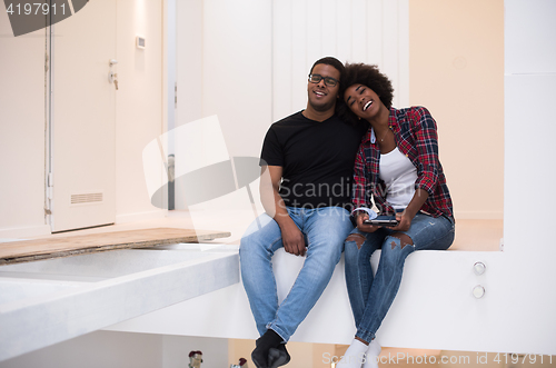 Image of couple having break during moving to new house