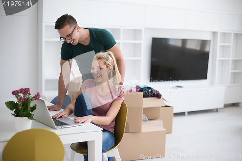 Image of Young couple moving in a new home