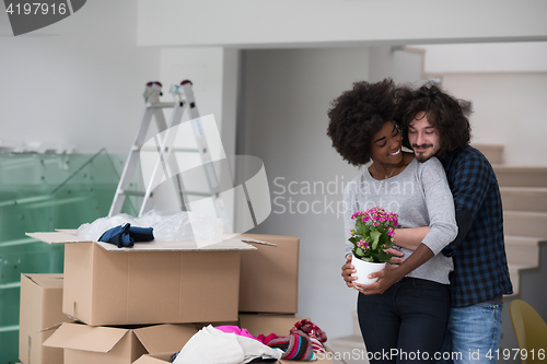 Image of multiethnic couple moving into a new home