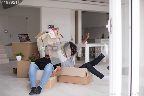 Image of African American couple  playing with packing material