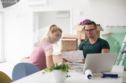 Image of Young couple moving in a new home