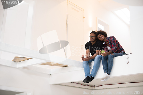 Image of couple having break during moving to new house