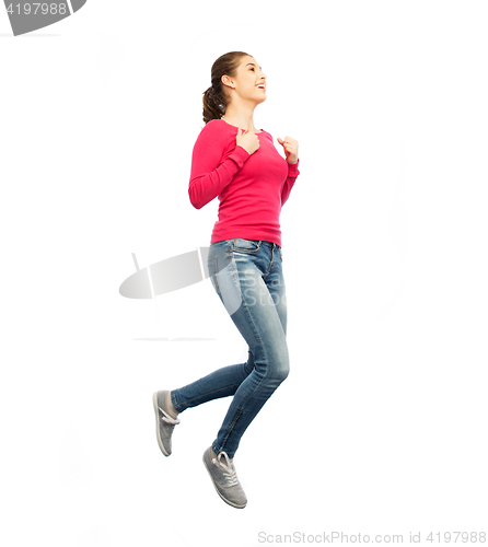 Image of smiling young woman jumping in air