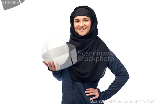 Image of happy muslim woman in hijab with volleyball