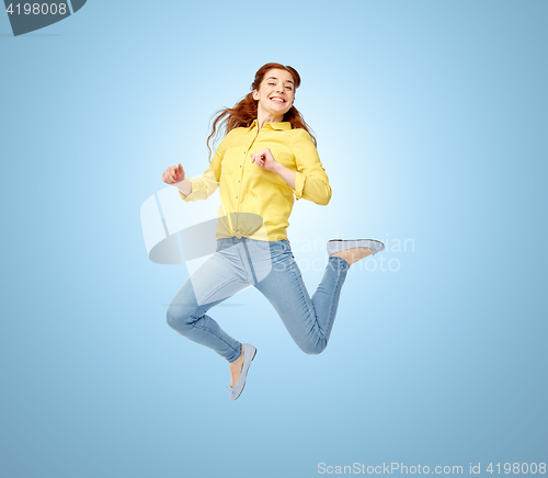 Image of smiling young woman jumping in air