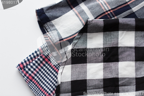 Image of close up of checkered shirt on white background