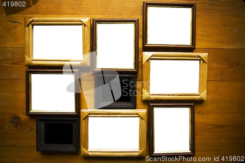 Image of empty picture frames on wooden wall