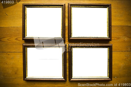 Image of empty picture frames on wooden wall