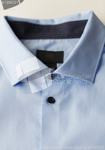 Image of close up of blue shirt collar