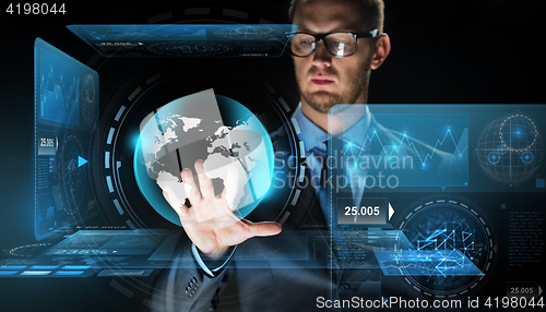 Image of businessman with virtual earth globe projection