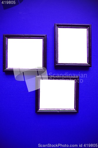 Image of empty picture frames on blue wall