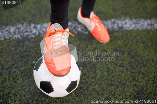 Image of soccer player playing with ball on football field