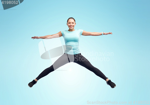 Image of happy smiling sporty young woman jumping in air