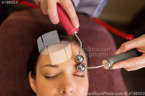 Image of woman having hydradermie facial treatment in spa