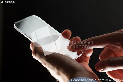 Image of close up of businessman with glass smartphone