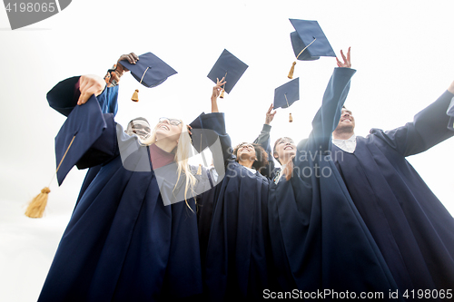 Image of happy students throwing mortar boards up