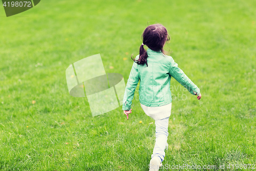 Image of little girl walking along summer green meadow