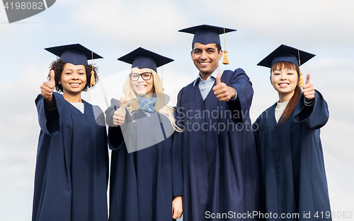 Image of happy students or bachelors showing thumbs up