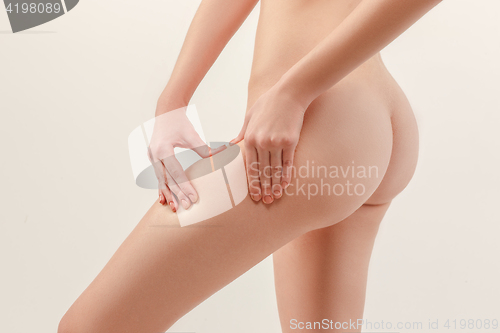 Image of Checking cellulite. Young, slim, healthy and beautiful woman