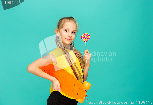 Image of Pretty skater girl holding skateboard