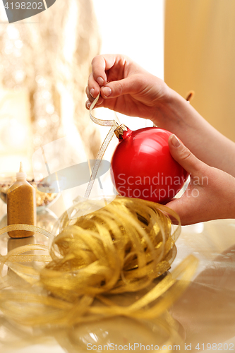 Image of Christmas preparations, the woman preparing decorations. 