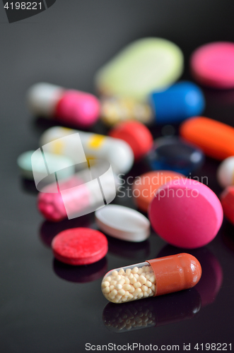 Image of many different pills on table