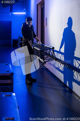 Image of Roadie carrying a big truss support