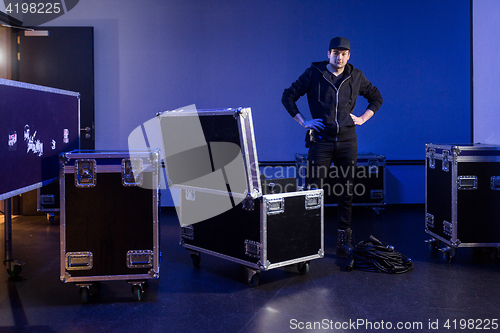 Image of Roadie standing next to an unpacked flightcase