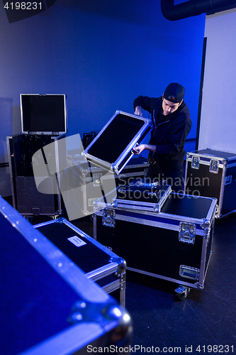 Image of Roadie unpacking a dj mixing table