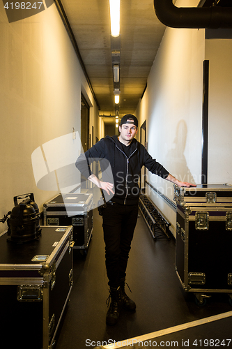 Image of Roadie standing between some flightcases