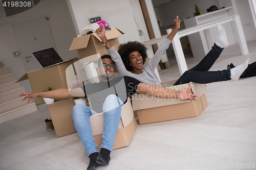 Image of African American couple  playing with packing material