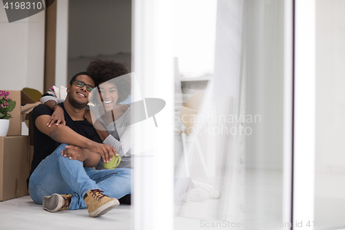 Image of African American couple relaxing in new house