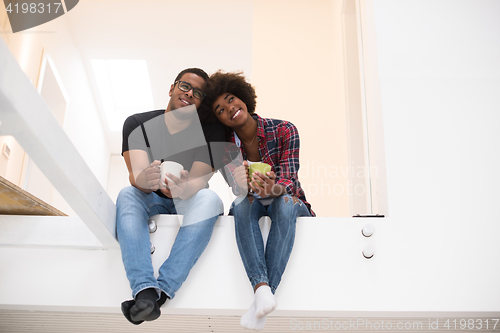 Image of couple having break during moving to new house