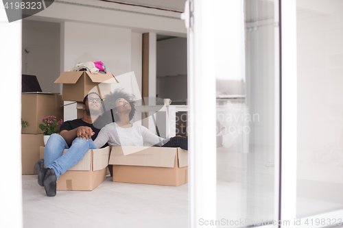 Image of African American couple  playing with packing material