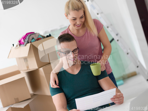 Image of Young couple moving in a new home