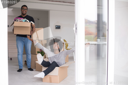 Image of African American couple  playing with packing material