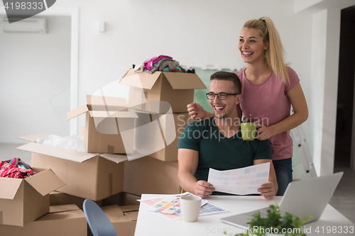 Image of Young couple moving in a new home