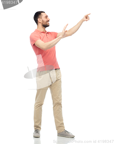 Image of happy man touching something imaginary