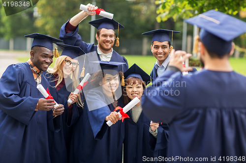 Image of students or bachelors photographing by smartphone