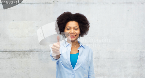 Image of happy afro american woman showing thumbs up