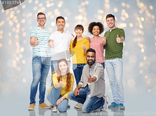 Image of international group of people showing thumbs up