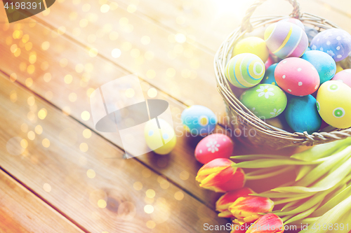 Image of close up of easter eggs in basket and flowers