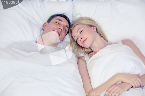 Image of happy couple sleeping in bed