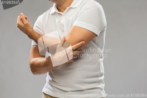 Image of close up of man suffering from pain in hand